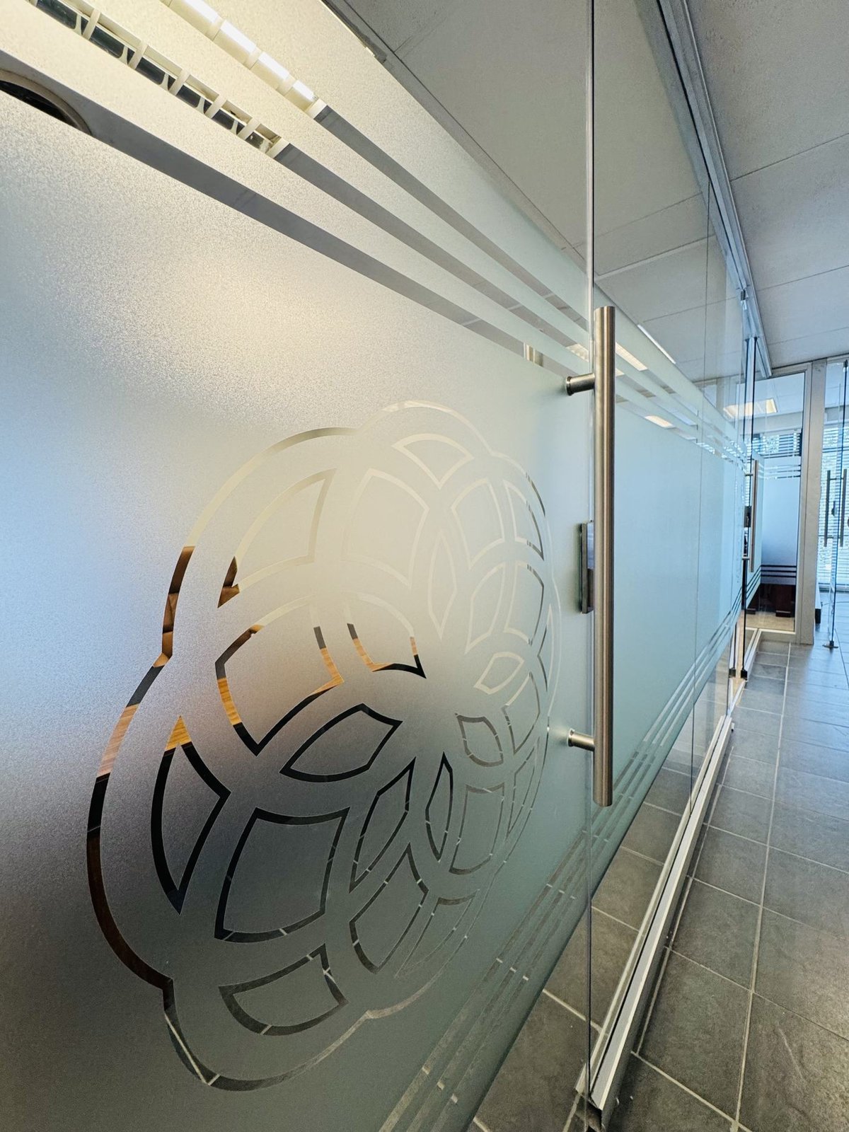 Frosted glass partition with a cut logo pattern